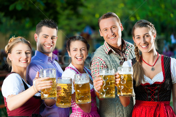 In Beer garden - friends drinking beer Stock photo © Kzenon
