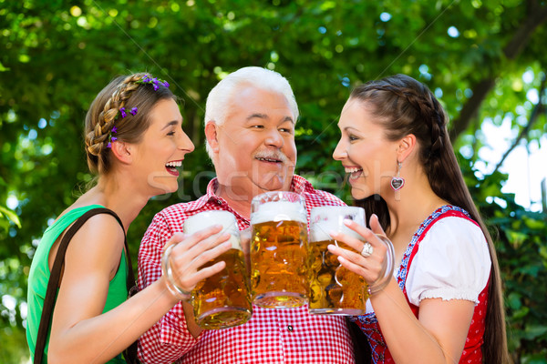 In Beer garden - friends drinking beer in bavaria Stock photo © Kzenon