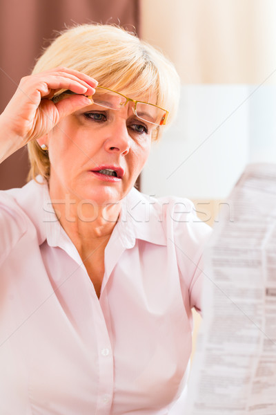 Senior reading with presbyopia package insert Stock photo © Kzenon