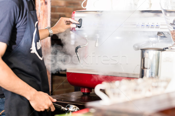Barista preparing coffee at steaming machine in cafe Stock photo © Kzenon