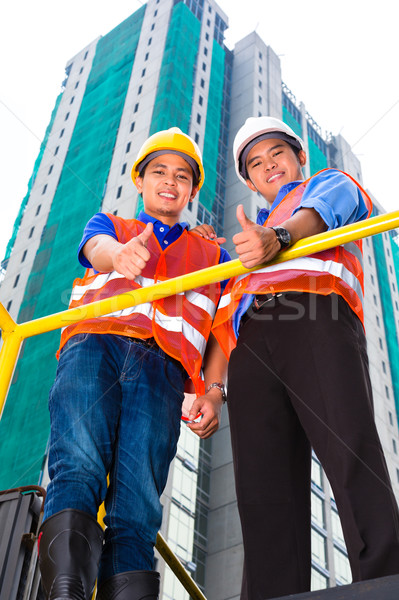 Asian architect and supervisor on construction site Stock photo © Kzenon