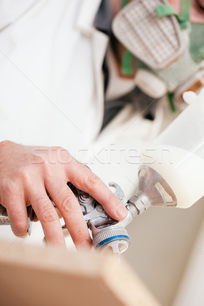 Carpenter painting wood with airbrush Stock photo © Kzenon