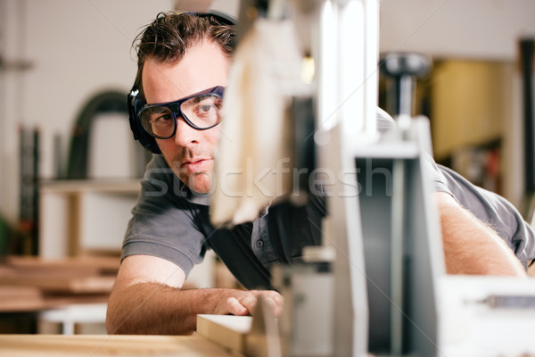 Carpenter using electric saw Stock photo © Kzenon
