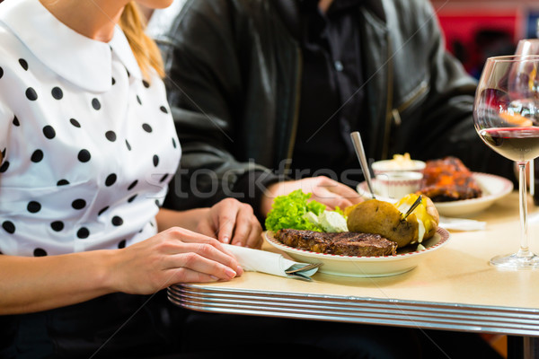 Friends or couple eating and drinking in fast food diner Stock photo © Kzenon