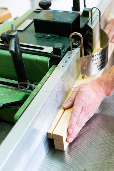 Carpenter with electric cutter Stock photo © Kzenon