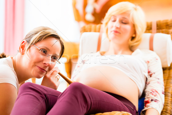 Midwife seeing mother for pregnancy examination Stock photo © Kzenon