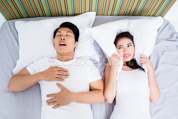Stock photo: Chinese man snoring keeping his wife awake