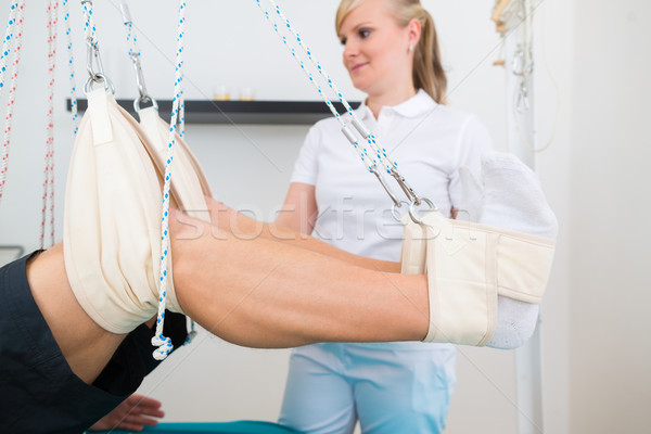 Physiotherapist with patient on sling table   Stock photo © Kzenon