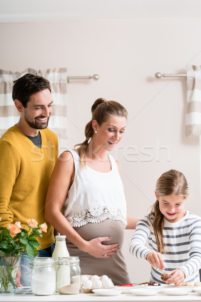 Family with pregnant mother baking together in kitchen Stock photo © Kzenon