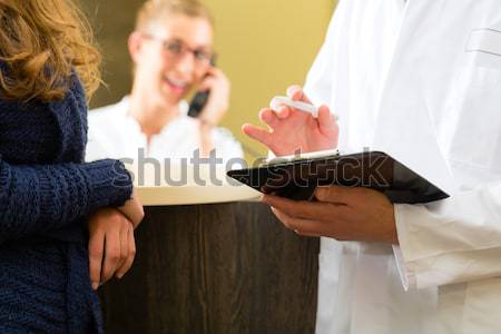 Woman and doctor at reception of clinic Stock photo © Kzenon