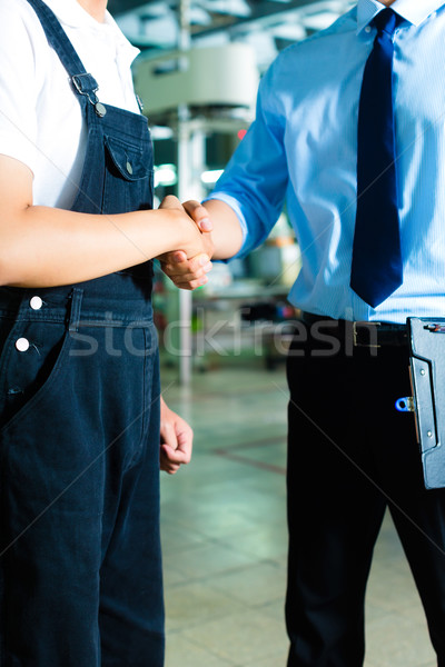 Worker and production manager in a factory Stock photo © Kzenon