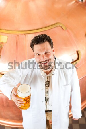 Man with beer glass in brewery Stock photo © Kzenon