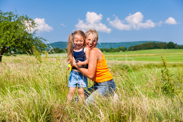 Mother and Daughter in summer on meadow Stock photo © Kzenon