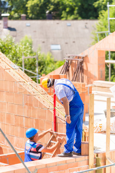 Worker checking walls on construction site Stock photo © Kzenon