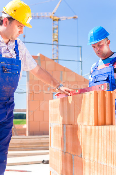 construction site worker checking building walls Stock photo © Kzenon