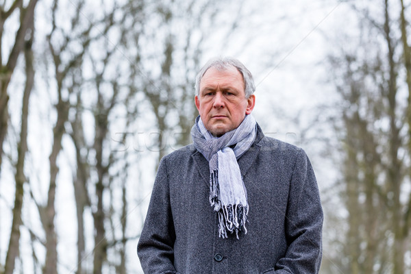 Depressed or sad man walking in winter Stock photo © Kzenon