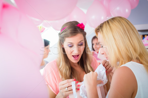 Stock photo: Woman giving gift to pregnant friend on baby shower