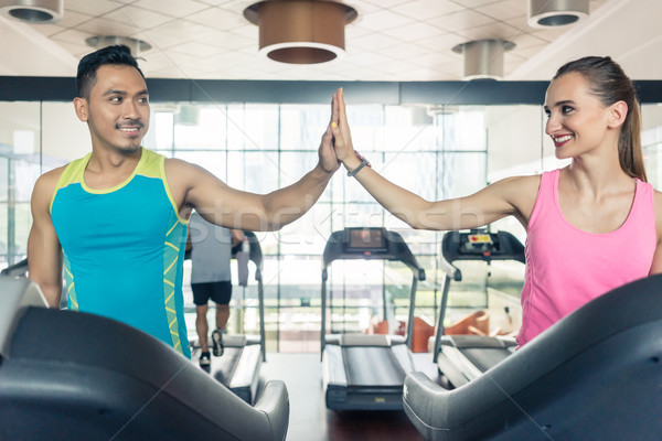 Handsome young man giving high five with his girlfriend before c Stock photo © Kzenon