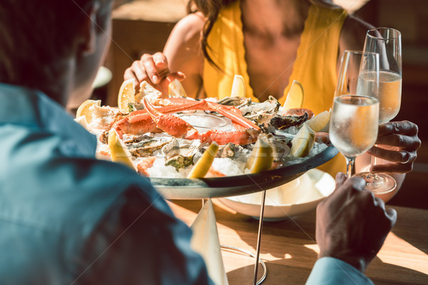 Stock photo: Close-up of fresh oysters and crabs served on ice with lemon