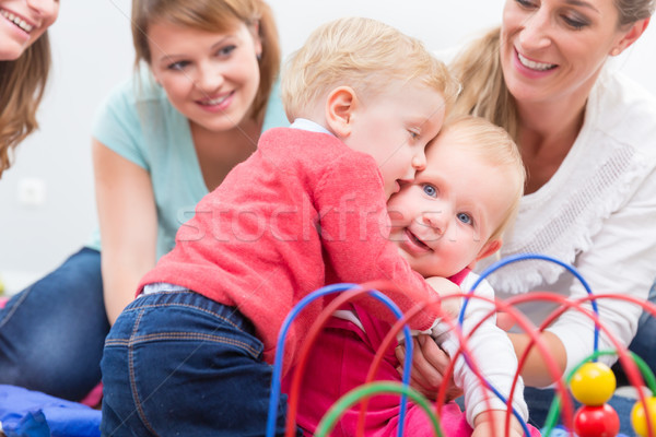 Stock photo: Group of happy young mothers watching their cute and healthy babies play