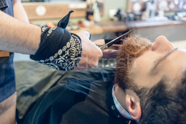 Close-up of the hand of a barber using scissors while trimming Stock photo © Kzenon