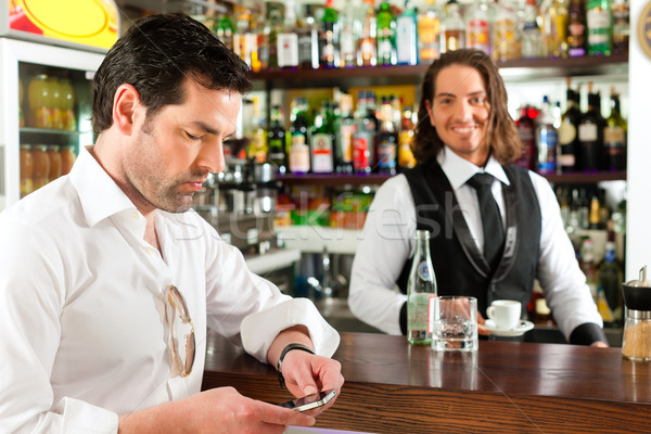 Stock photo: Barista with client in his cafe or coffeeshop