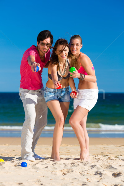 Man and women playing boule on beach Stock photo © Kzenon