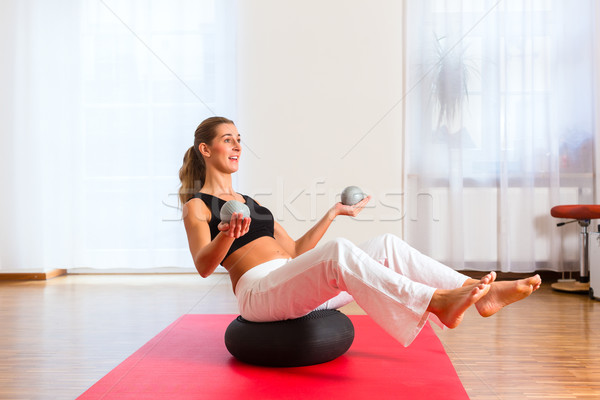 woman practicing poses on exercise ball Stock photo © Kzenon