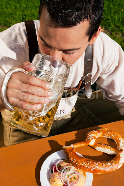 Man in Lederhosen drinking beer Stock photo © Kzenon