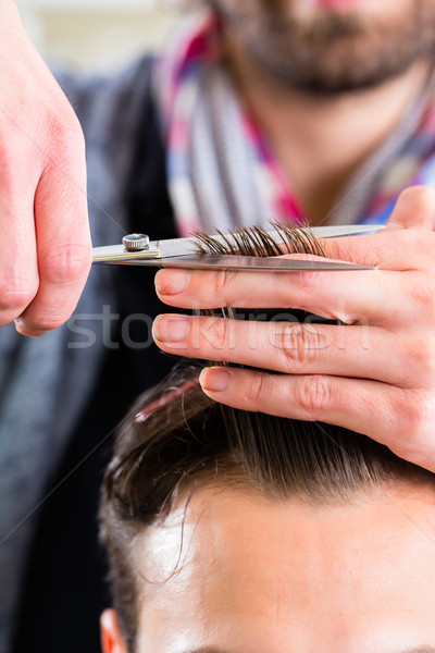 Barber trimming man hair in haircutter shop Stock photo © Kzenon
