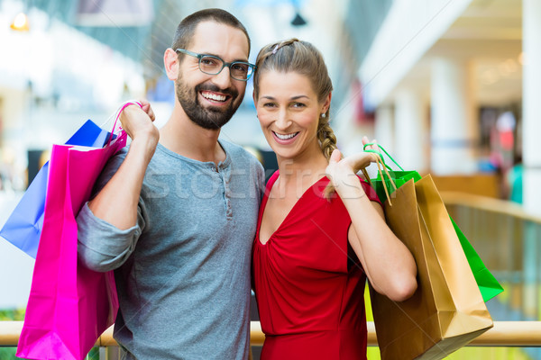 Man and woman in shopping mall with bags Stock photo © Kzenon