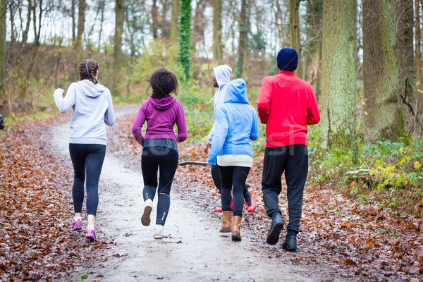 Fitness trainer guiding group of four determined young people du Stock photo © Kzenon