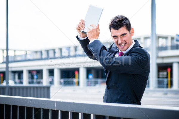Angry business man with tablet computer Stock photo © Kzenon