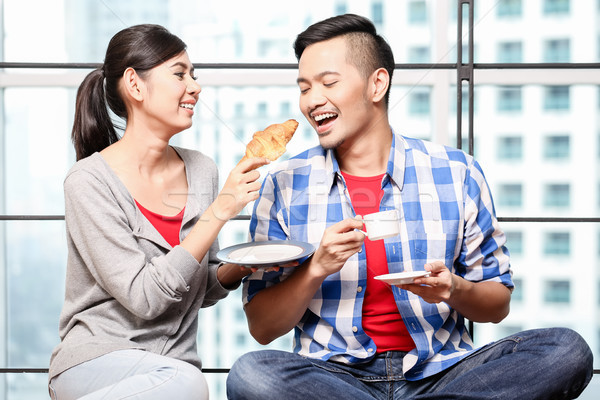 Young asian couple having breakfast together Stock photo © Kzenon