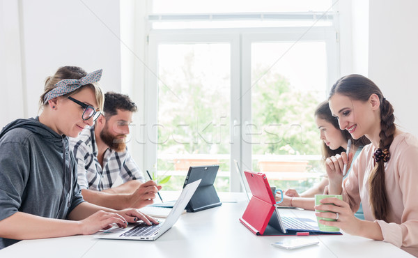 Dedicated young people sharing a desk while telecommuting Stock photo © Kzenon