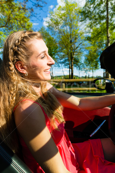 Young woman with cabriolet in summer on day trip Stock photo © Kzenon