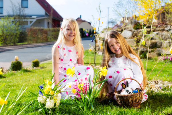 Children on Easter egg hunt with bunny Stock photo © Kzenon