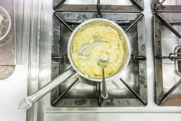 Pot with mashed potatoes on gas stove in restaurant kitchen Stock photo © Kzenon