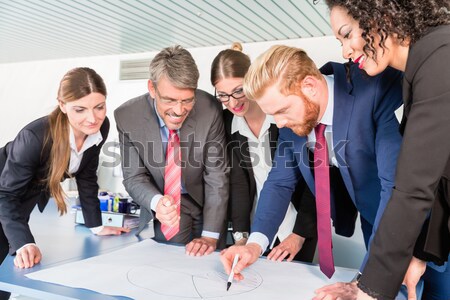Group of business people analyzing data Stock photo © Kzenon