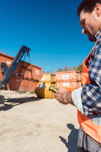 Man loading of construction debris container on truck Stock photo © Kzenon