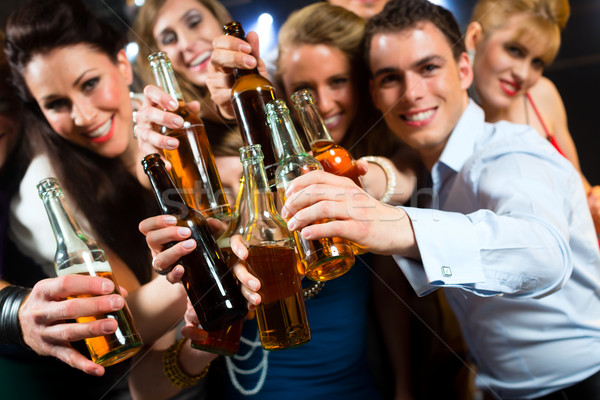 People in club or bar drinking beer Stock photo © Kzenon