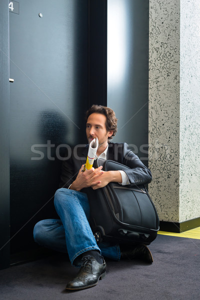 Young guest in front of hotel room door Stock photo © Kzenon