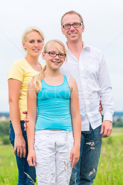 Family standing on grass of lawn or field Stock photo © Kzenon