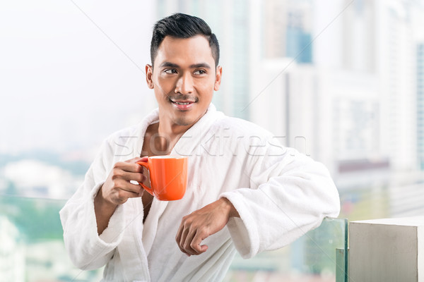 Asian man in morning front of city skyline Stock photo © Kzenon