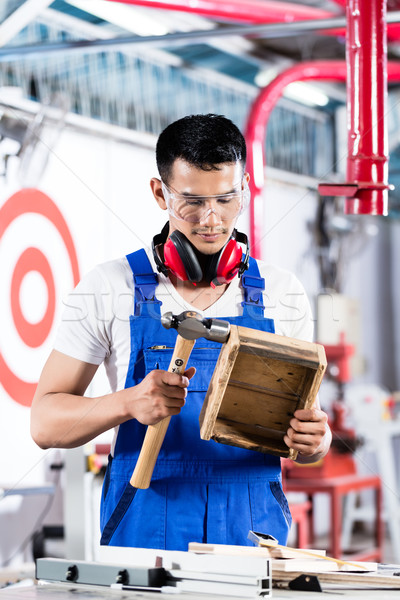 Stock photo: Asian Carpenter in wood workshop working 