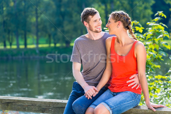 Couple sitting at riverbank in summer Stock photo © Kzenon