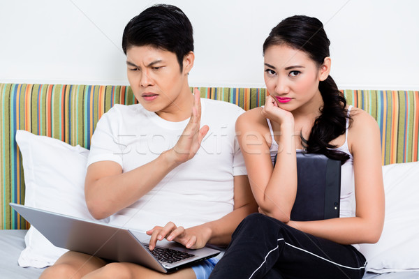 Unhappy Asian couple having issues surfing the internet Stock photo © Kzenon