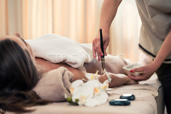 Woman lying down during Asian anti-aging treatment Stock photo © Kzenon