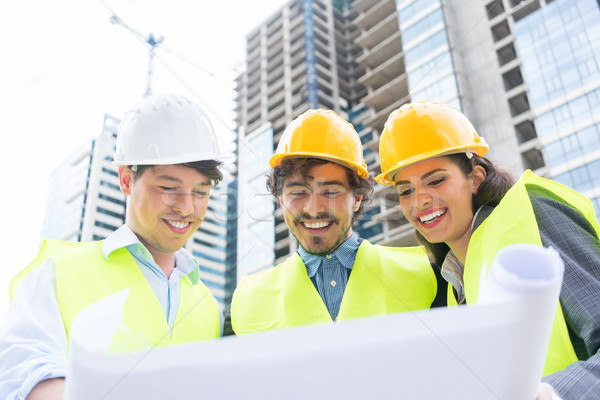 Architects with ground plot on construction site Stock photo © Kzenon