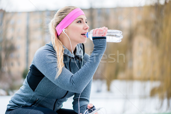 Woman resting from jogging or sport on winter day Stock photo © Kzenon